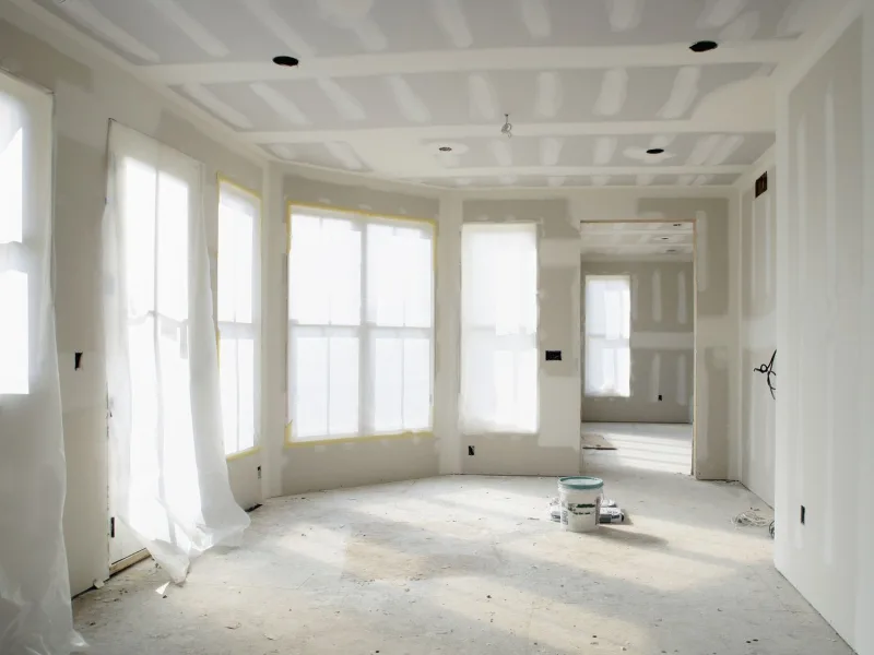 Smooth finished drywall walls under strong daylight